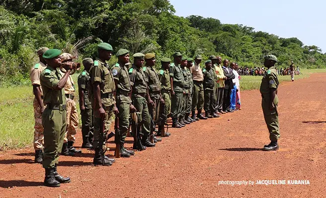 Eco-guards at Bili-Uele prepare to welcome a high-level delegation from the European Union on a visit to the landscape A group of rangers standing at attention at a guard of honor in the Democratic Republic of Congo