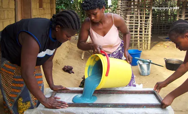 AWF helps train women to run conservation enterprises to advance gender equality and protect biodiversity Photo of three women making soap at AWF training center in the Democratic Republic of Congo